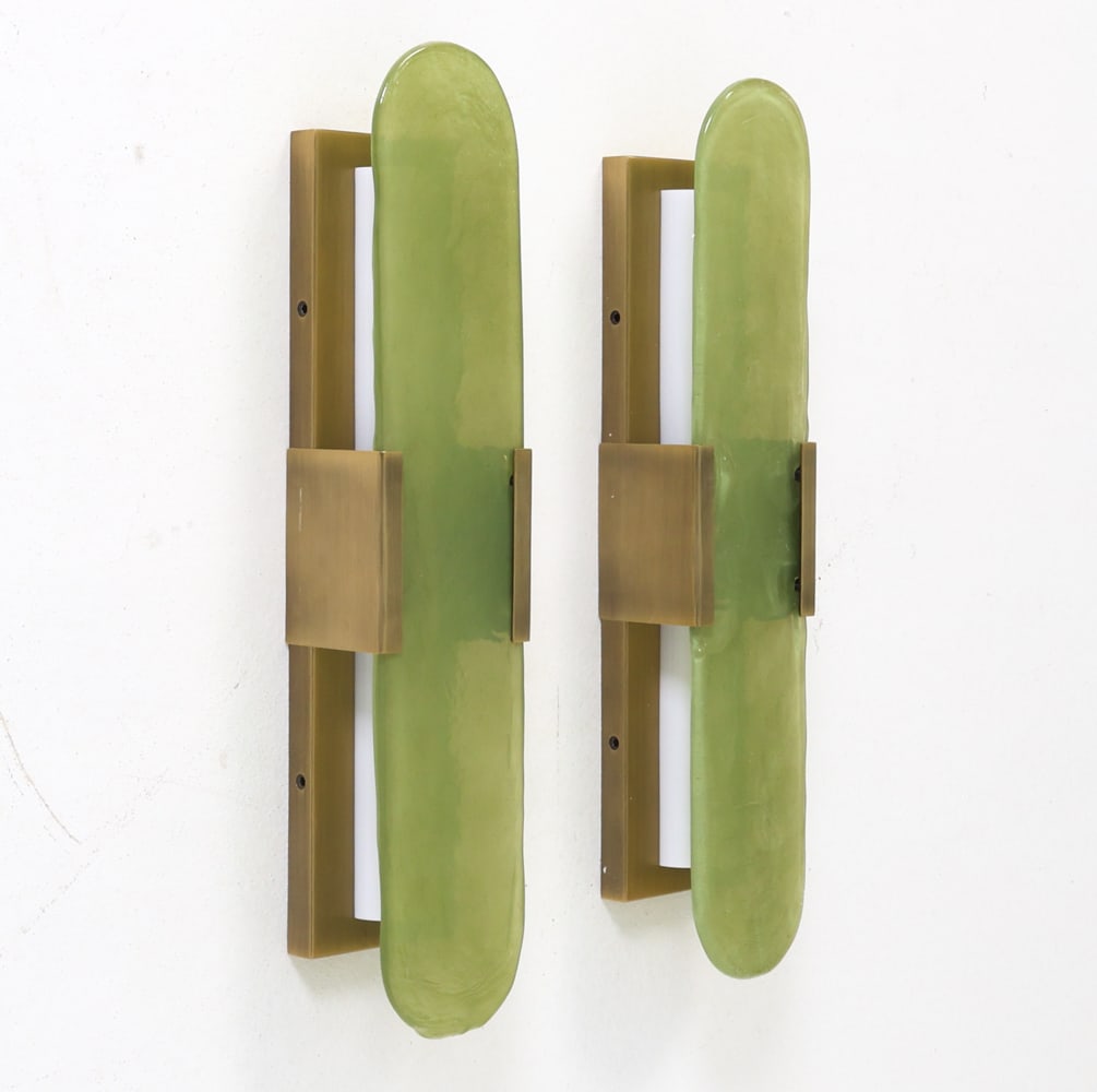 PAIR OF BRASS & GLASS CONTEMPORARY WALL SCONCES: Custom made sconces featuring vertical rectangular brass wall mounts with larger green glass shades. In original box. Dimensions: H 16.5 " x W 4.25" x D 3" Condition: Not Tested. Appears to be in like