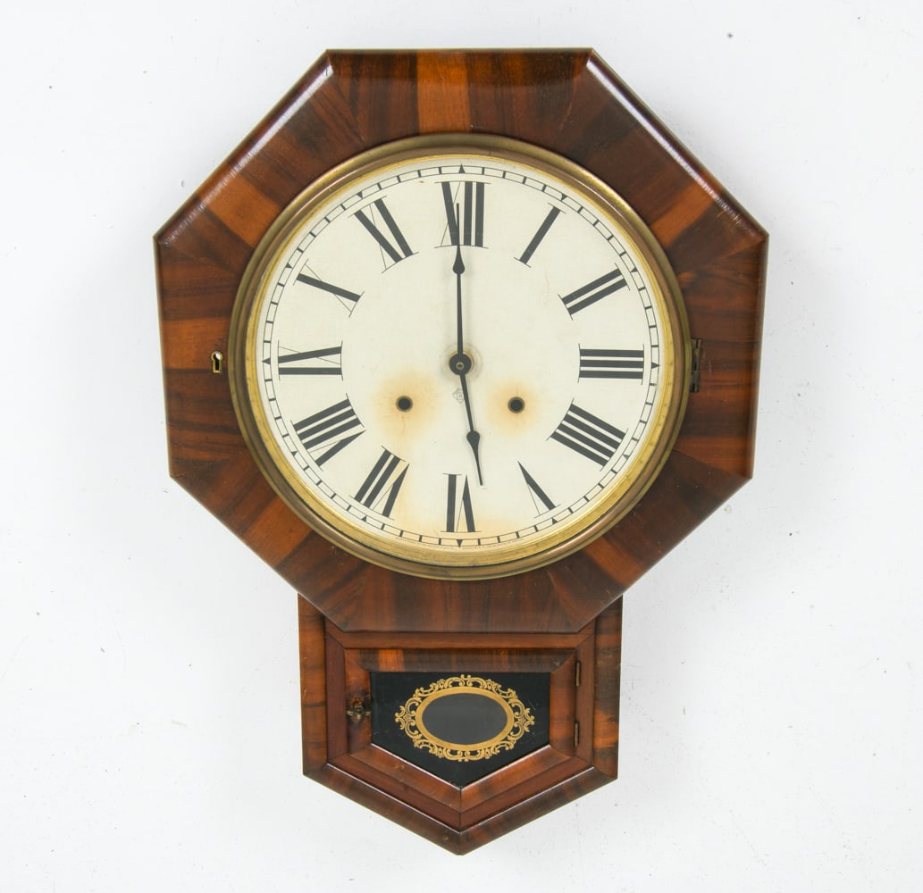 ANTIQUE ANSONIA SHORT DROP WALL CLOCK 19TH C.: Features distinctive walnut case with octagonal top housing a dial with Roman numerals. Late 19th Century. Dimensions: H 24" x W 16" x D 3" Condition: Wear consistent with age and use. Missing pendulu