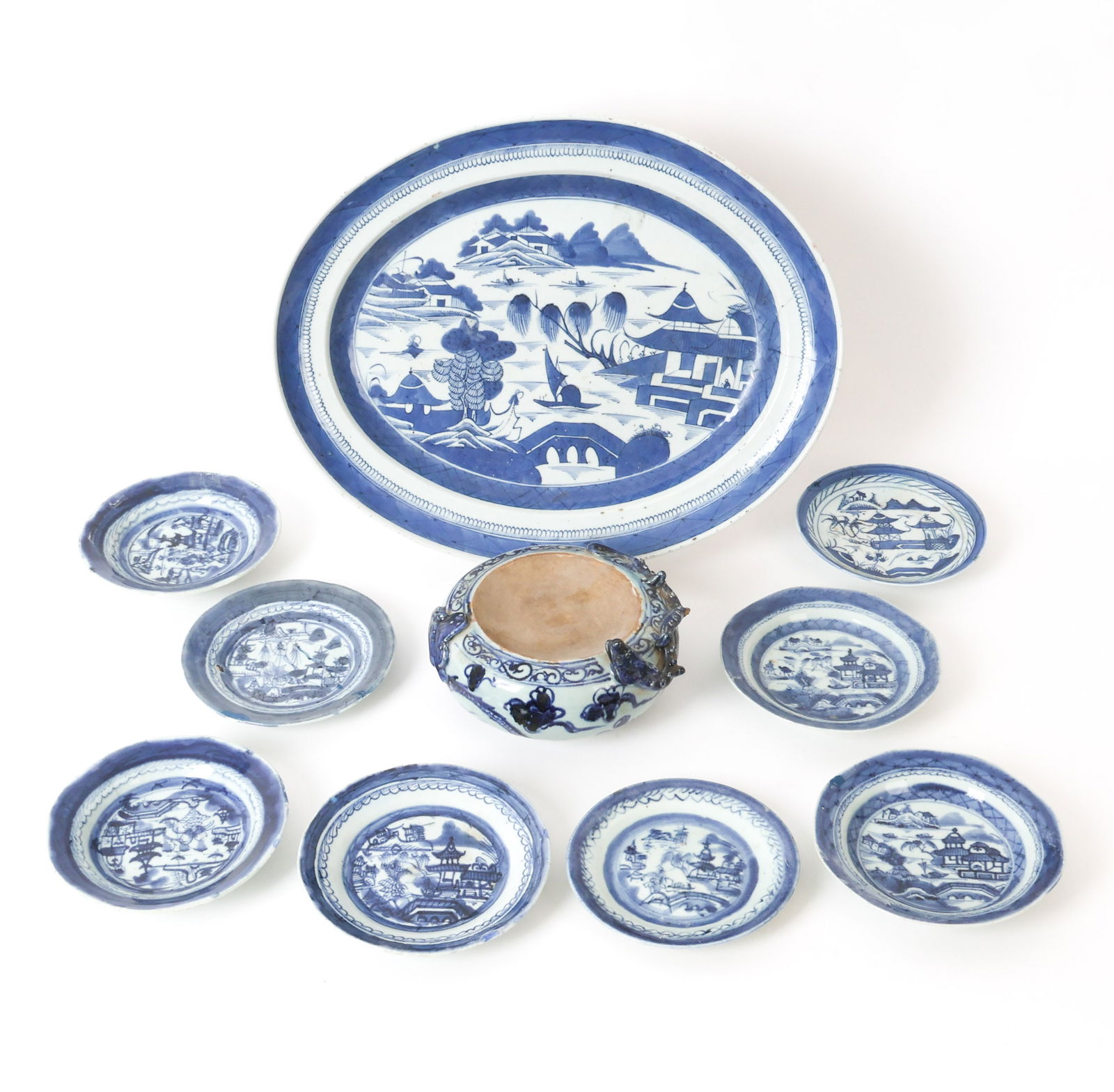 GROUPING OF CHINESE BLUE & WHITE PORCELAIN: Grouping of Chinese porcelain with blue and white landscape patterns. Includes (8) smaller dishes, one larger platter and a holding dish with dragon detail. All apparently unmarked. Dimensions: (Large