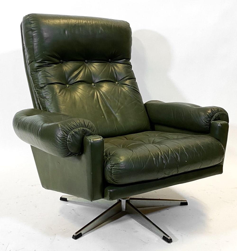 ATTR. NILI STOPPMOBLER LEATHER LOUNGE CHAIR 1970S: Tufted green leather upholstery on steel swivel base. Denmark, circa 1970s. Dimensions: H 36" x W 36" x D 36" S.H. 17". Condition: Showing signs of wear including scratches and small rip to back top