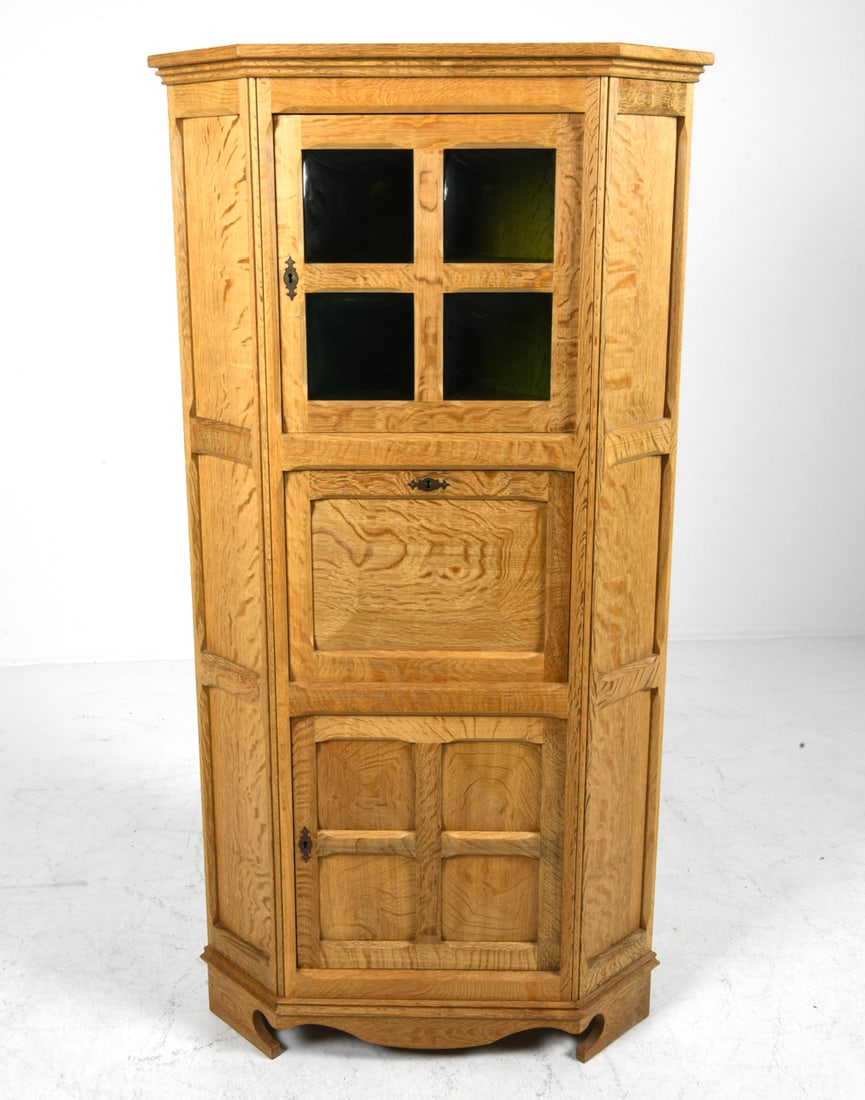 DANISH OAK CORNER CABINET C. 1970S: (2) Keys Included. Convex glass panels to cabinet door. Denmark, circa 1970s. Marked Scan Rustik Dimensions: H 67" x W 34.5" x D 23". Condition: Light surface wear consistent with age and use.