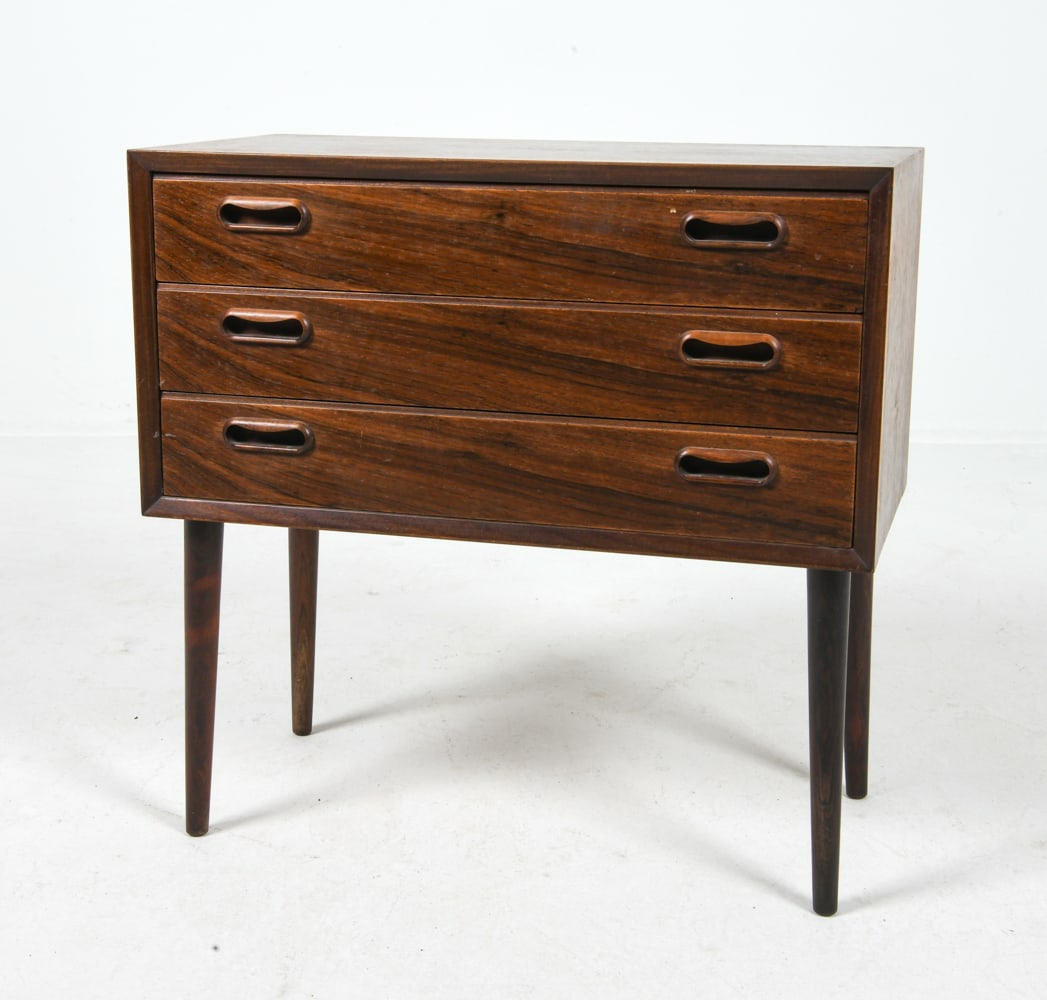 ATTR. JOHANNES SORTH ROSEWOOD SIDE CHEST C. 1960S: Danish rosewood chest of drawers with tapered legs. Molded inset drawer pulls. Denmark, circa 1960s. Dimensions: H 23" x W 23.5" x D 12". Condition: Few scuffs and scratches to frame, wear consistent