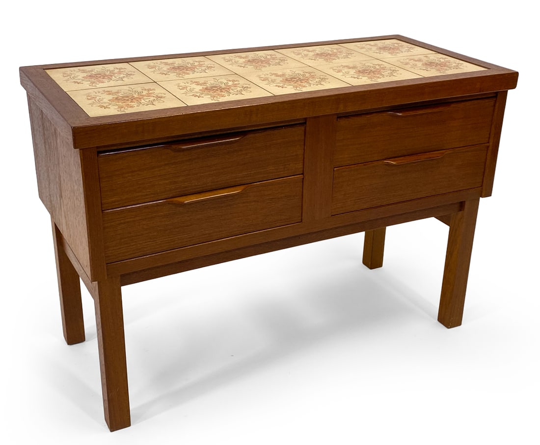 DANISH TEAK & TILE LOW CHEST C. 1970S: Teak chest of drawers with ceramic tiles inlaid to top. Denmark, circa 1970s. Dimensions: H 22.25" x W 32.75" x D 14.75". Condition: Dings and rubs to edges of top and sides, Wear consistent with age