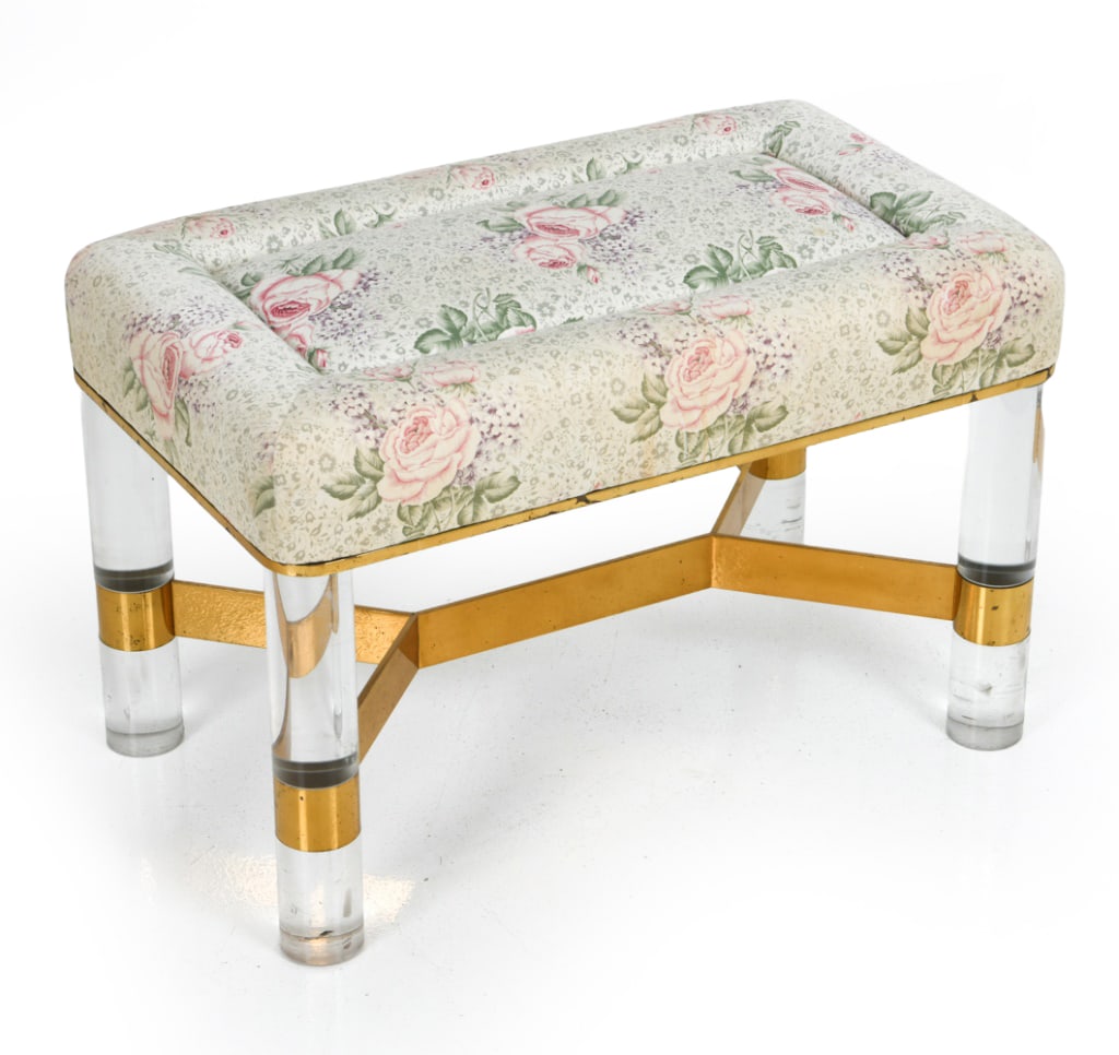 KARL SPRINGER LUCITE & BRASS BENCH C. 1980S: Clear cylindrical lucite frame and X-shaped polished brass with floral upholstered seat. Signed to stretchers. circa 1980s. Dimensions: H 18" x W 27" x D 15.5" Condition: Wear consistent with age and