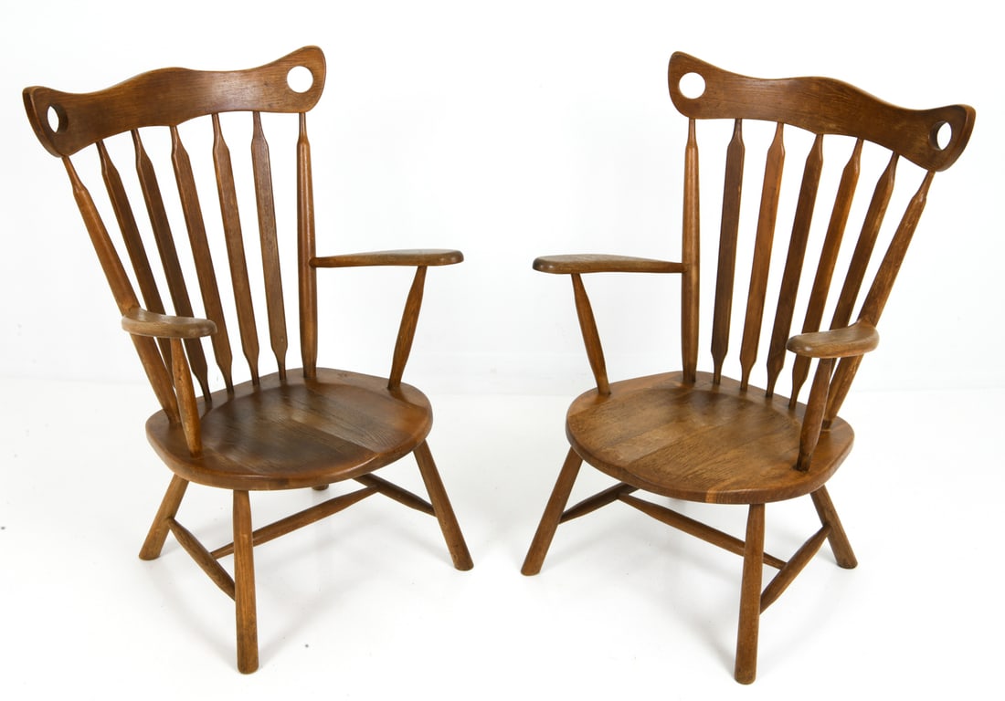 PAIR STYLE OF GELDERLAND DUTCH OAK ARMCHAIRS 1950S: Two chairs with vertical flat spindles backrest, carved seat and armrests. Netherlands, circa 1950s. Dimensions: H 36" x W 24" x D 22" x SH 14" Condition: Few scuffs to frame, nail marks to