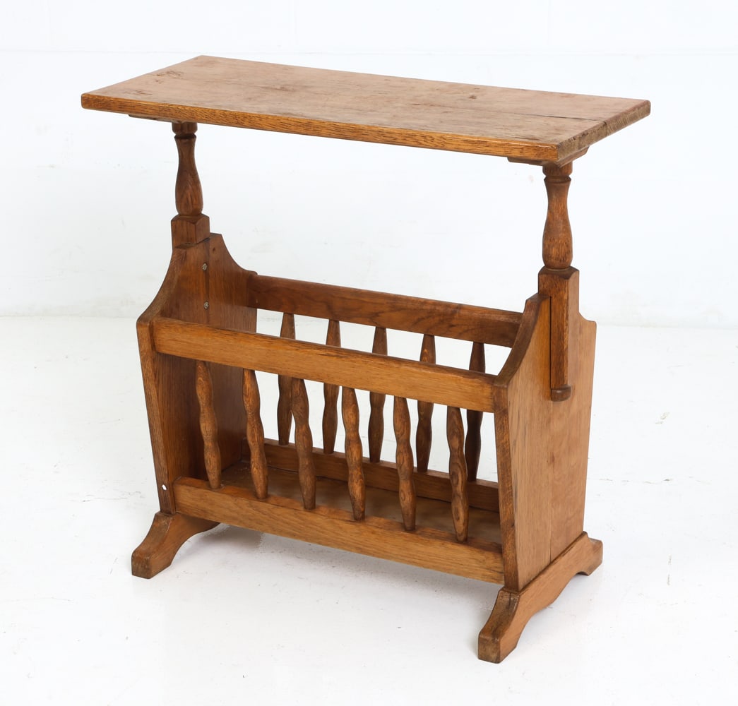 RHONFORM GERMAN OAK MAGAZINE RACK SIDE TABLE 1970S: Carved oak magazine rack or side table. Marked underneath. Germany, circa 1970's. Dimensions: H 22" x W 22.5" x D 9" Condition: Scuffs to top. Minor nicks to frame. Wear consistent with age and use. S