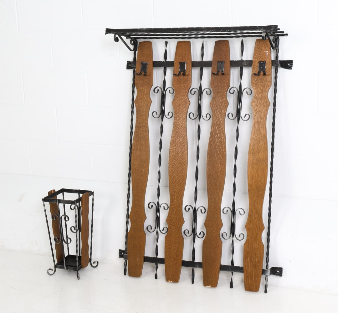 GERMAN OAK COAT RACK & UMBRELLA STAND GROUPING: Cast aluminum frame and oak slat coat rack and umbrella stand. Germany, circa 1970's. Dimensions: (Coat rack) H 48" x W 33" x D 11" (Umbrella stand) H 17" x W 8" x 7.25" Condition: Paint loss to metal