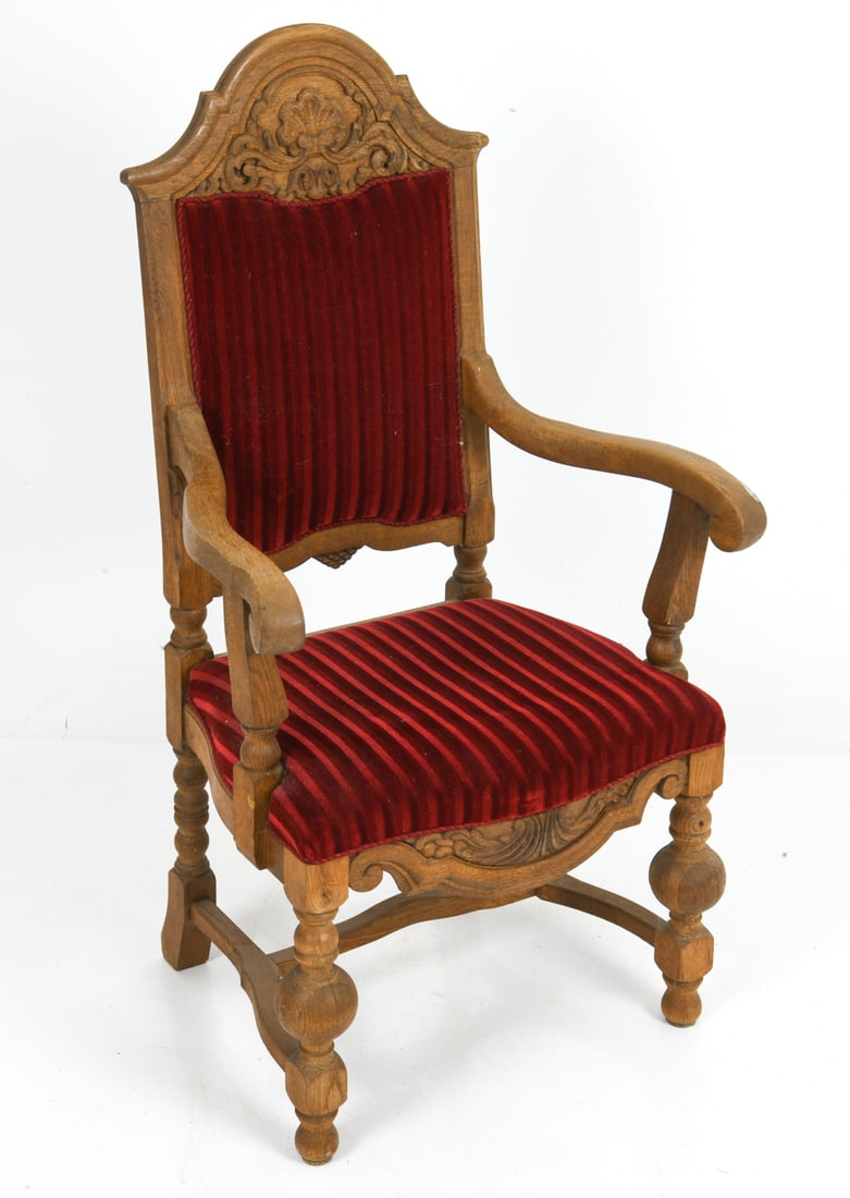 DANISH OAK HIGHBACK ARMCHAIR C. 1930S: Antique carved oak armchair with red striped velvet upholstery. Scrolled armrests and turned feet with stretcher base. Denmark, circa 1930s. Dimensions: H 47" x W 26" x D 22" x SH 18" Condition: Wear