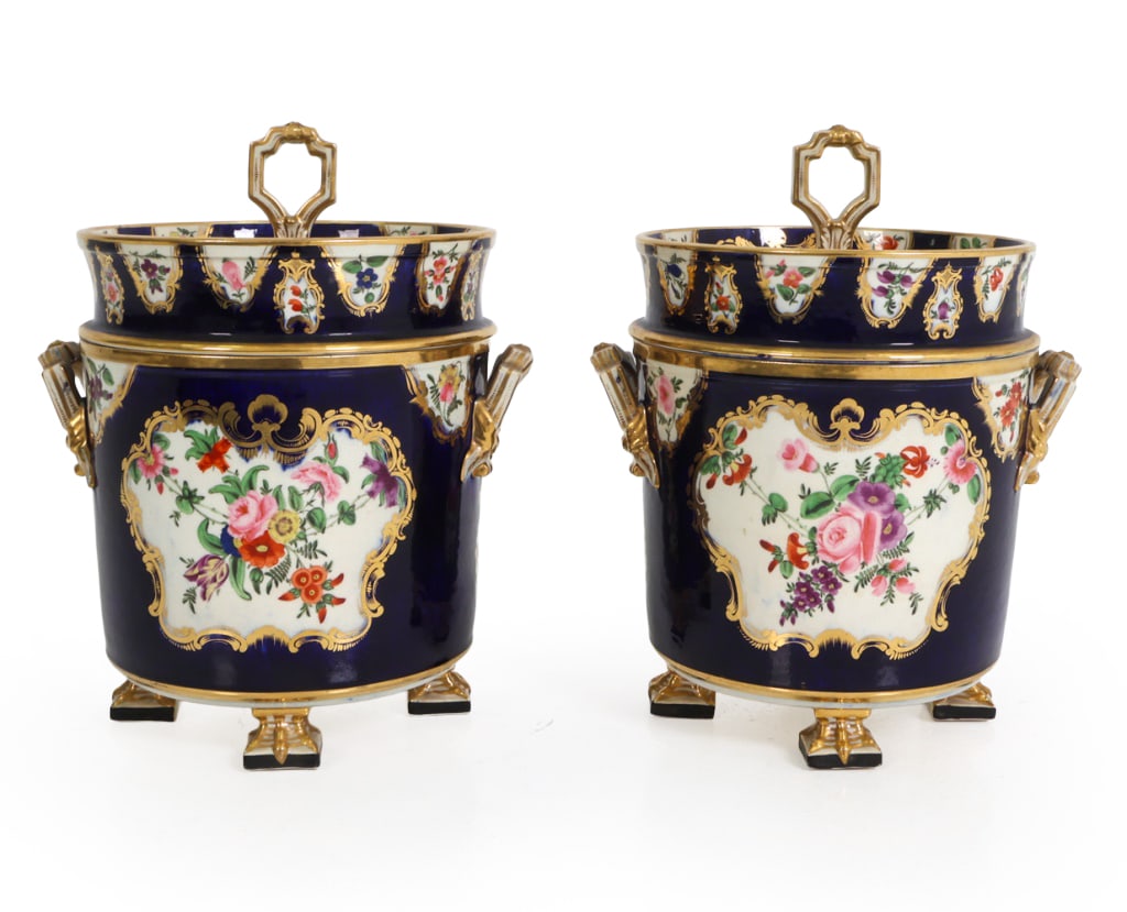PAIR OF FRENCH OLD PARIS PORCELAIN CACHEPOTS: Vieux Paris porcelain lidded bucket or cooler with a cobalt blue ground on four gilt paw feet. Gilt scrollwork and polychrome floral bouquets cartouches decoration. Openwork handles and covers with lo
