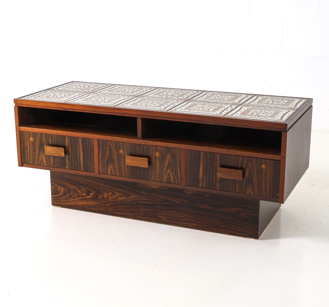 BREDEBRO DANISH ROSEWOOD CHEST OF DRAWERS 1960S: Rosewood veneer chest with three drawers, featuring inlaid ceramic tile top. Apparently unmarked. Denmark, circa 1960s. Dimensions: H 17.5" x W 41" x D 17" Condition: Wear consistent with age and