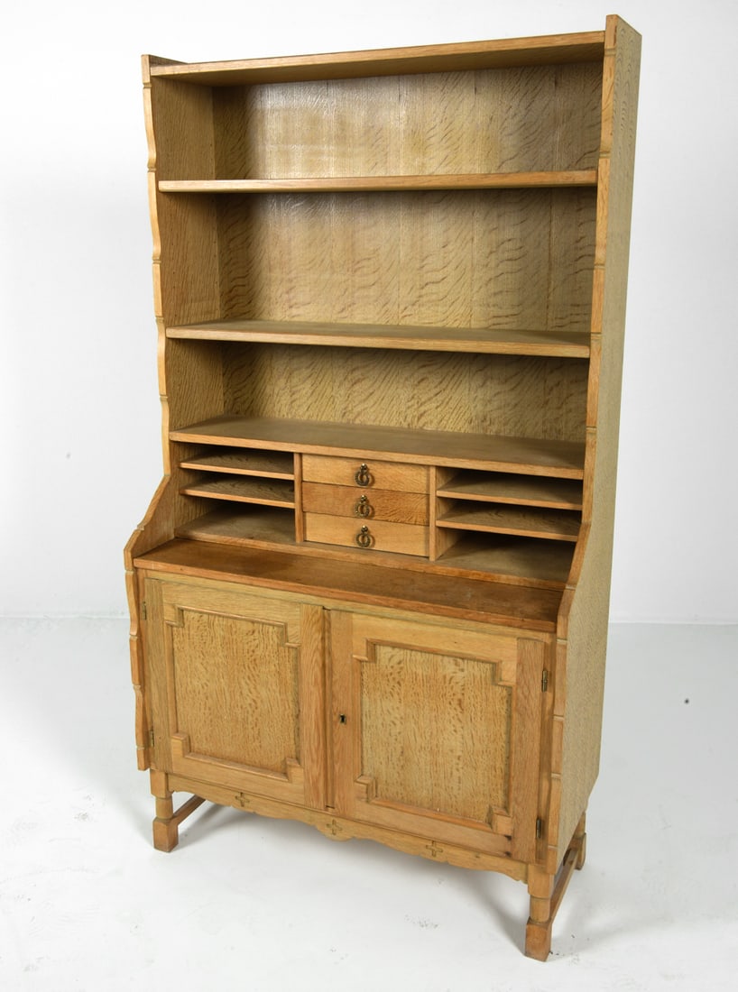 EGEREOLER NORWEGIAN OAK BOOKCASE CABINET 1970S: Key included. Tagged to back. Pull-out desk and adjustable shelves. Brass pulls. Carved decoration to lower apron. Norway, circa 1970s. Dimensions: H 72" x W 39" x D 16.5". Pull-out Desk 15". Conditio