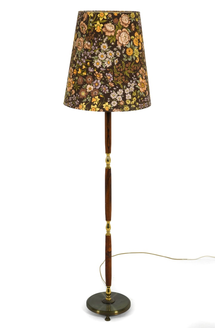 LAONI DANISH ROSEWOOD & BRASS FLOOR LAMP C. 1960S: Floor lamp with rosewood and brass stand. Floral design to shade. Paw feet. Denmark, circa 1960s. Dimensions: H 63" x Dia. 17.5". Condition: Wiring untested, European plug. Few scratches to base.