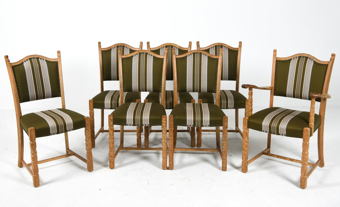 (7) STYLE OF KJAERNULF DANISH DINING CHAIRS 1970S: (6) Side chairs and (1) armchair. Oak frames with stripe pattern upholstery. Brass tacks accents. Denmark, circa 1970s. Dimensions: H 37.5" x W 23" x D 17.5" x SH 18". Condition: Minor scuffs to wood.