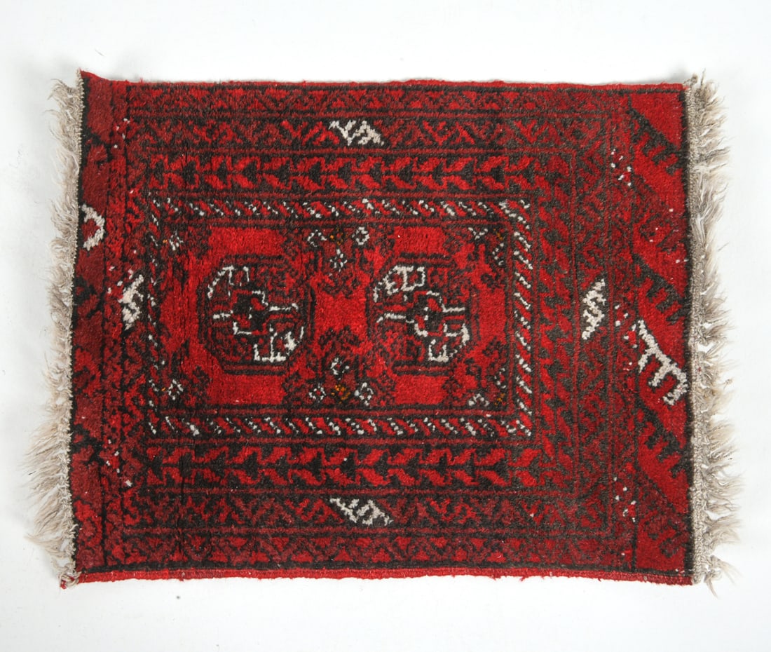 HAND-KNOTTED ORIENTAL PRAYER RUG: Oriental rug with red and white geometric design. Mid 20th century. Dimensions: L 26.5" x W 20". Condition: Slight fading, minor losses to fringe. Wear consistent with age and use.