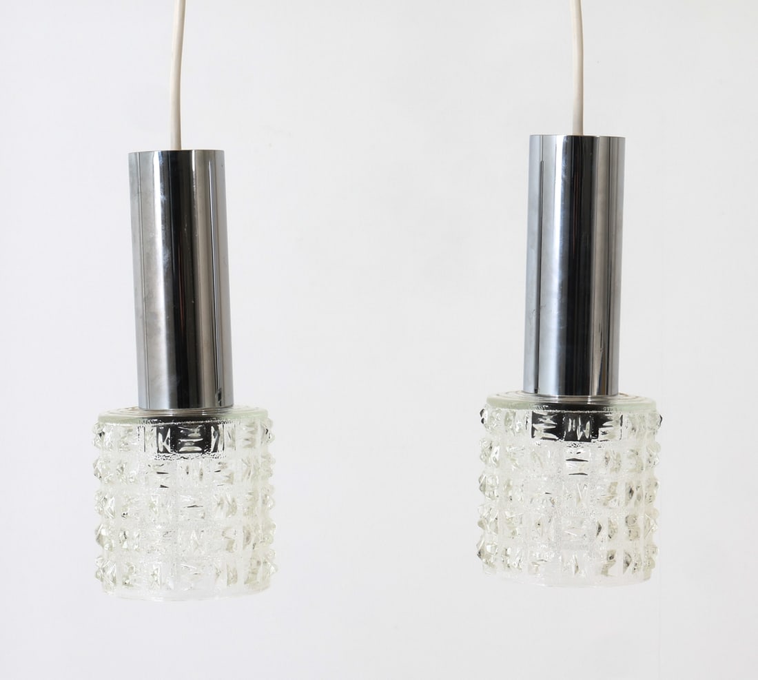 PAIR OF SCANDINAVIAN GLASS & CHROME PENDANT LIGHTS: Denmark, circa 1960's. Dimensions: H 11" x Dia. 4.5" Condition: Not Tested. Wear consistent with age and use.