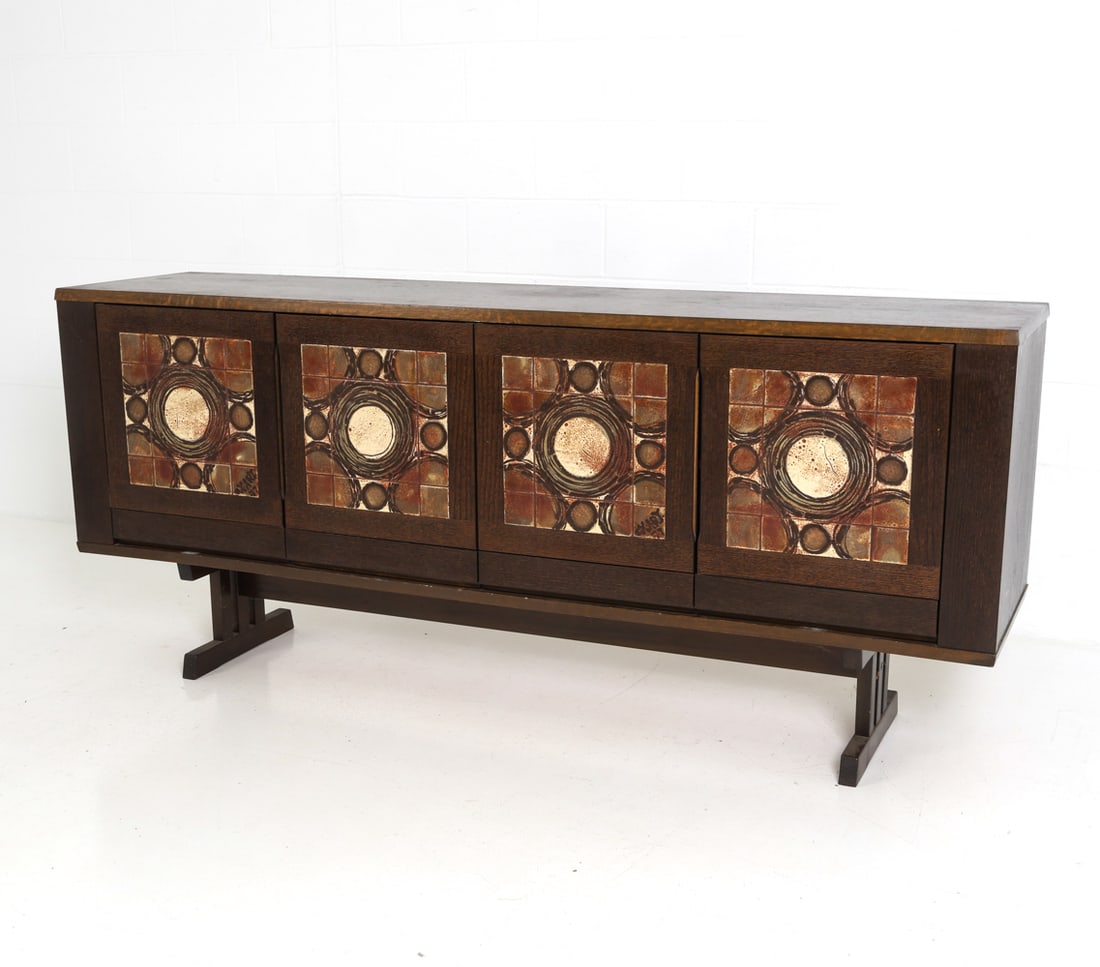 SKOVBY DANISH OAK & TILE SIDEBOARD C. 1960S: Oak sideboard with inset ceramic tiles to door fronts with circular and geometric patterns. Apparently unmarked. Denmark, circa 1960s. Dimensions: H 34" x W 78.5" x D 18.5" Condition: Stress crack to