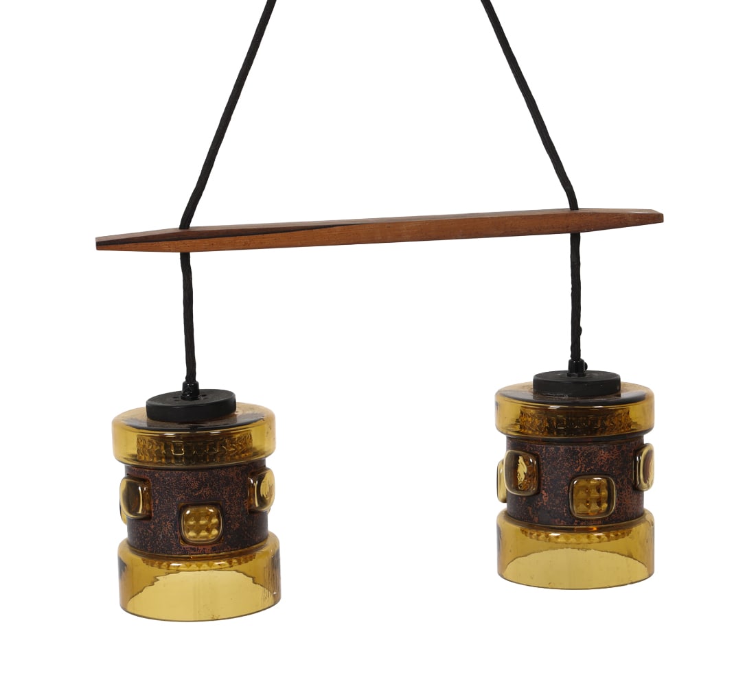 ATTR. NANNY STILL MCKINNEY TWO-LIGHT PENDANT LAMP: Featuring a rosewood beam suspension holding two amber-colored textured glass shades. Apparently unmarked. European, circa 1960's. Dimensions: H 10.25" x W 16" x D 4.5" Condition: Not Tested. Minor