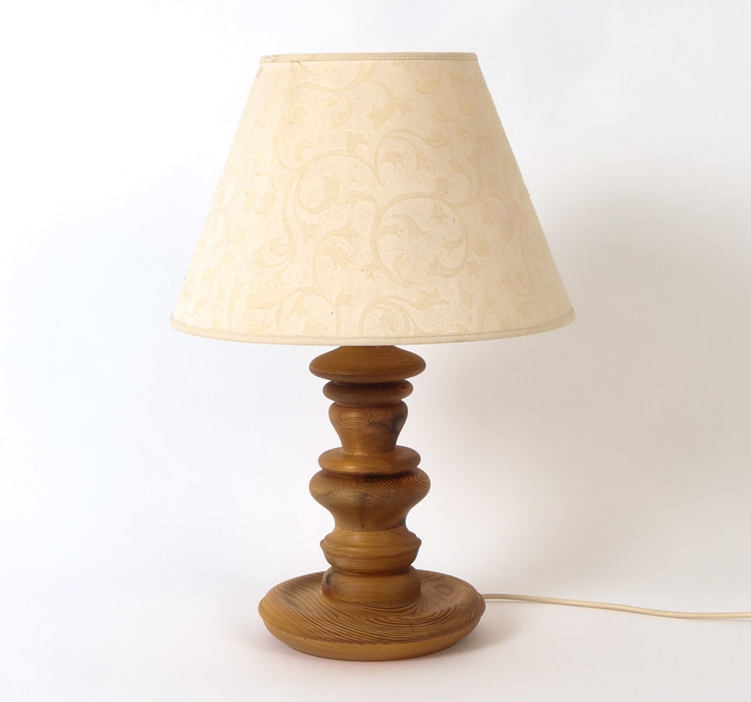 SCANDINAVIAN PINE TABLE LAMP CIRCA 1960'S: Turned pine table lamp with shade. Scandinavian, circa 1960's. Dimensions: H20 " x D 14" Condition: Not Tested, European Plug. Minor stress crack to base. Wear consistent with age and use.