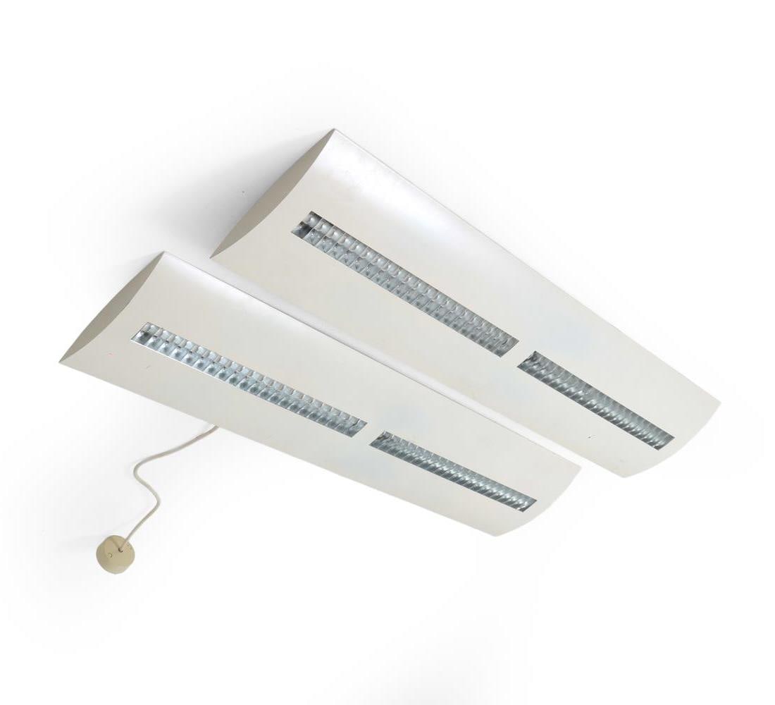 PAIR OF LOUIS POULSEN 'MALMO TRIO' LIGHT FIXTURES: Pair of ceiling light fixtures that hold three bulbs. Both labeled at top. Dimensions: H 1.25" x W 47.25" x D 10.5" Condition: One with one ceiling cap and lacking one, other lacking two. Surface