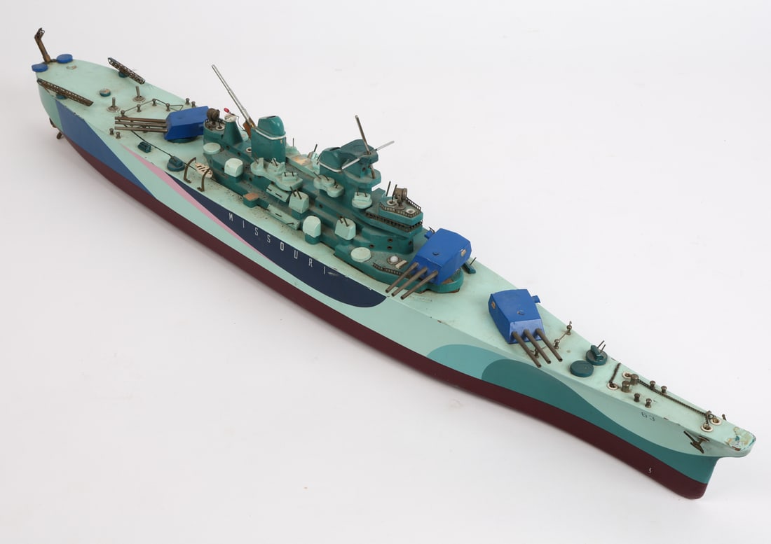 VINTAGE HAND-MADE MISSOURI BATTLESHIP MODEL: painted wood, Ship name and number on port and starboard. Dimensions: H 7.5" x W 32" x D 4". Condition: Showing signs of wear including scuffs and small areas of paint loss consistent with age and