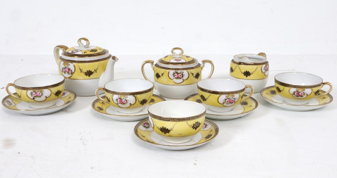 NORITAKE MEDUSA CERAMIC TEA SERVICE: Marked underneath. Includes (13) pieces. Mid 20th century. Dimensions: (largest teapot) H 5" x W 8" x D 5". Condition: With chip and previous repair to lid of sugar bowl. Rubs to gilding. Wear