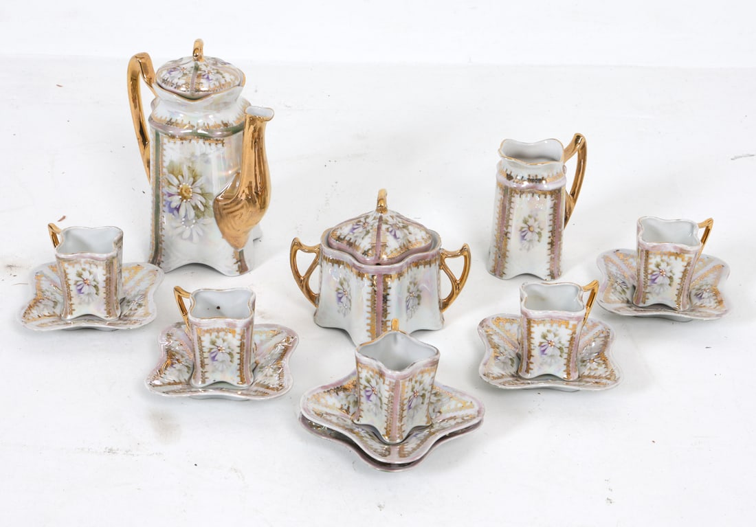 GERMAN CERAMIC TEA SERVICE: Marked Made in Germany underneath. Includes (14) pieces total. 20th century. Dimensions: (largest) H 7.5" x W 6.5" x D 4". Condition: With chip and previous repair to lid of sugar jar. Couple tiny