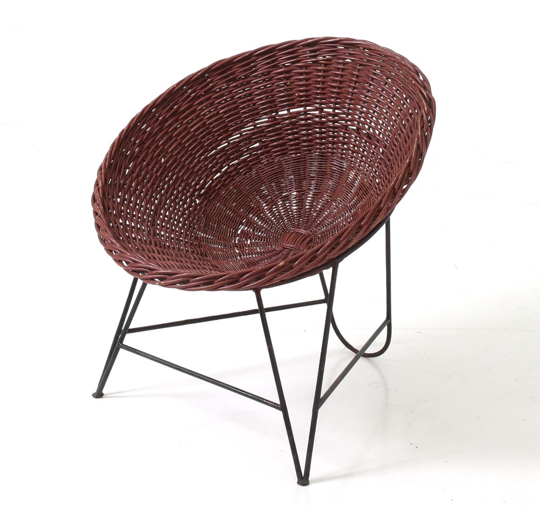 ATTR MATHIEU MATEGOT FRENCH WICKER TUB CHAIR 1950S: Wicker basket chair in black bent metal frame and woven natural wicker seat. Apparently unmarked. Circa 1950's. Dimensions: H 27.5" x W 29" x D 26" x Sh 16.5" Condition: Wear consistent with age and