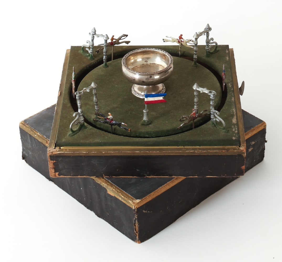 ANTIQUE 'JEU DE COURSE' FRENCH HORSE RACING GAME: Antique children's horse racing game with a lever to spin the horses and a sterling silver cup in the center. Manufactured by the company M. J. & Cie in France, circa 1910s. Marked on side. Dimensions