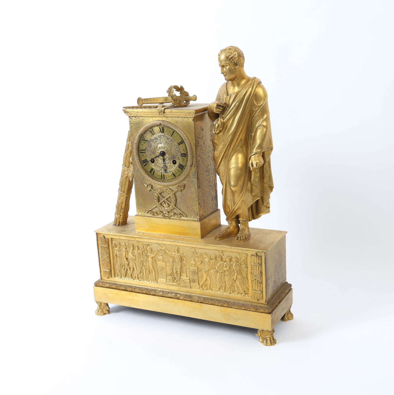 19TH C. FRENCH EMPIRE STYLE MANTLE CLOCK: Brass mantle clock featuring a classical Roman or Greek figure standing beside the clock. Apparently unmarked. Dimensions: H 19.5" x W 14.25" x D 4.75" Conditions: Not Tested, Wear consistent with