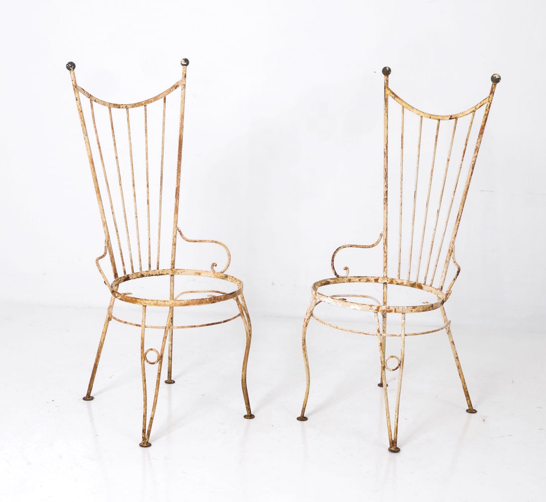 (2) MANNER OF TEMPESTINI WROUGHT IRON CHAIRS 1950S: Mid century wrought iron garden chairs with vertical rods backrest and scrolled arms. Dimensions: H 42.5" x W 17" x D 19" x Sh 17" Condition: Lacking seats, Wear consistent with age and use including