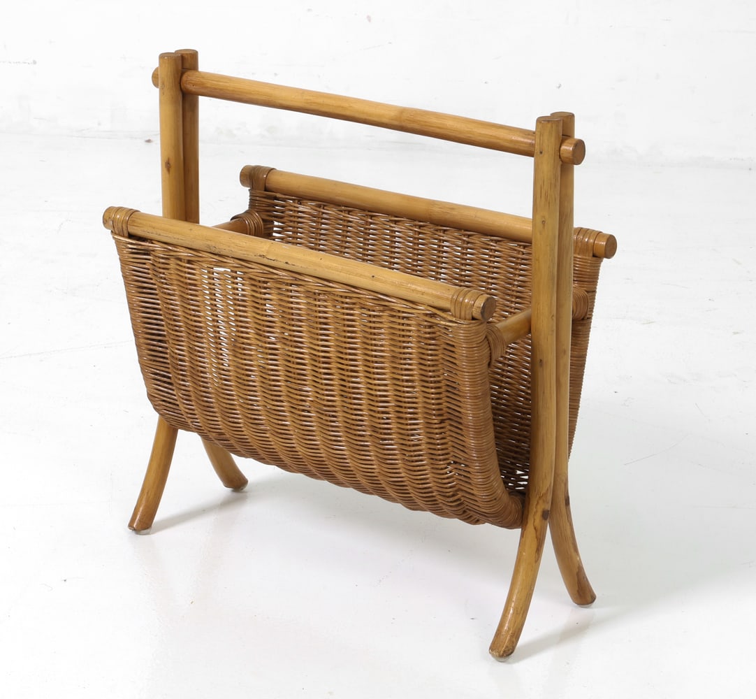 DUTCH BAMBOO & WICKER MAGAZINE RACK C. 1970S: Bamboo frame magazine rack with a woven interior. Unmarked. Dimensions: H 19.25" x W 18.75" x D 9" Condition: Losses to reed and light surface marks and dings to bamboo, wear consistent with age and u