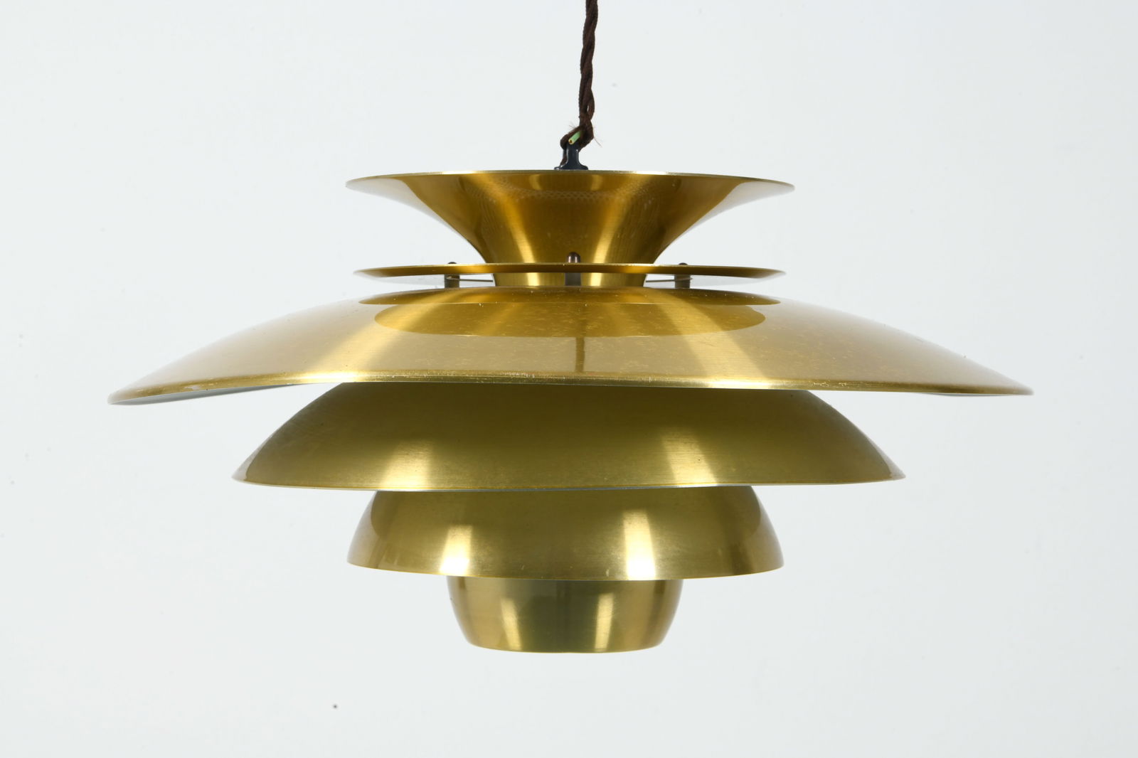JEKA STYLE DANISH PENDANT LIGHT C. 1970S: Brass toned metal pendant light with tiered shades. Denmark, circa 1970s. Dimensions: Dia. 16". H 8". Condition: Small Dents and slight warping/bending to largest saucer. Wear consistent with age and