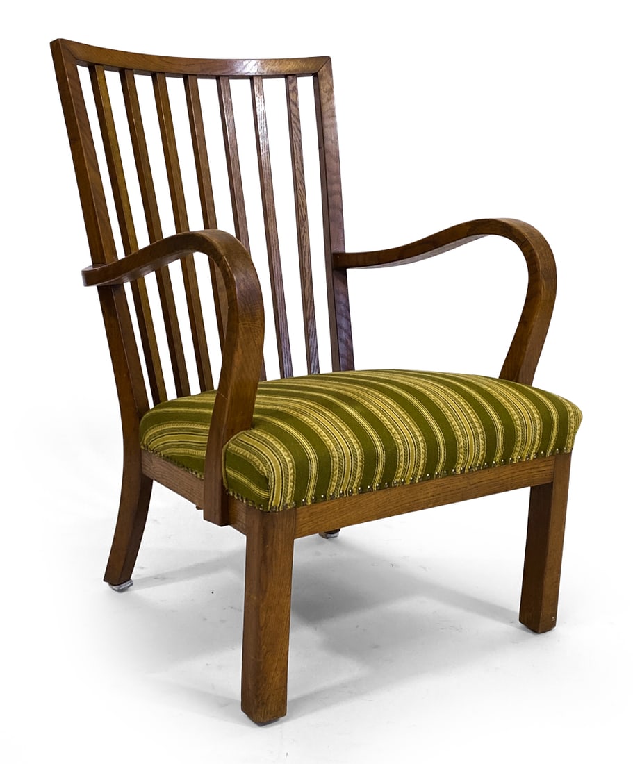 FRITZ HANSEN STYLE DANISH OAK LOUNGE CHAIR C.1940S: Slatted back and curved armrests. Green striped pattern upholstery with brass tacks detail. Denmark, circa 1940s. Dimensions: H 36" x W 25" x D 26" x SH 14.5". Condition: Minor scuffs and few water sp
