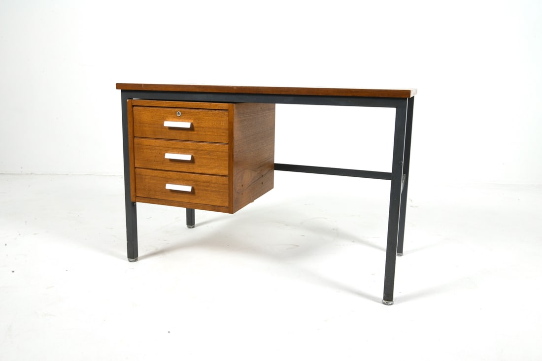 STYLE OF HERBERT HIRCHE TEAK WRITING DESK C. 1960S: German teak writing desk with steel legs. Brushed aluminum drawer pulls. Germany, circa 1960s. Dimensions: H 26.5" x W 39.5" x D 19.75" Condition: No key. Few scratches and scuffs to top and drawer pu