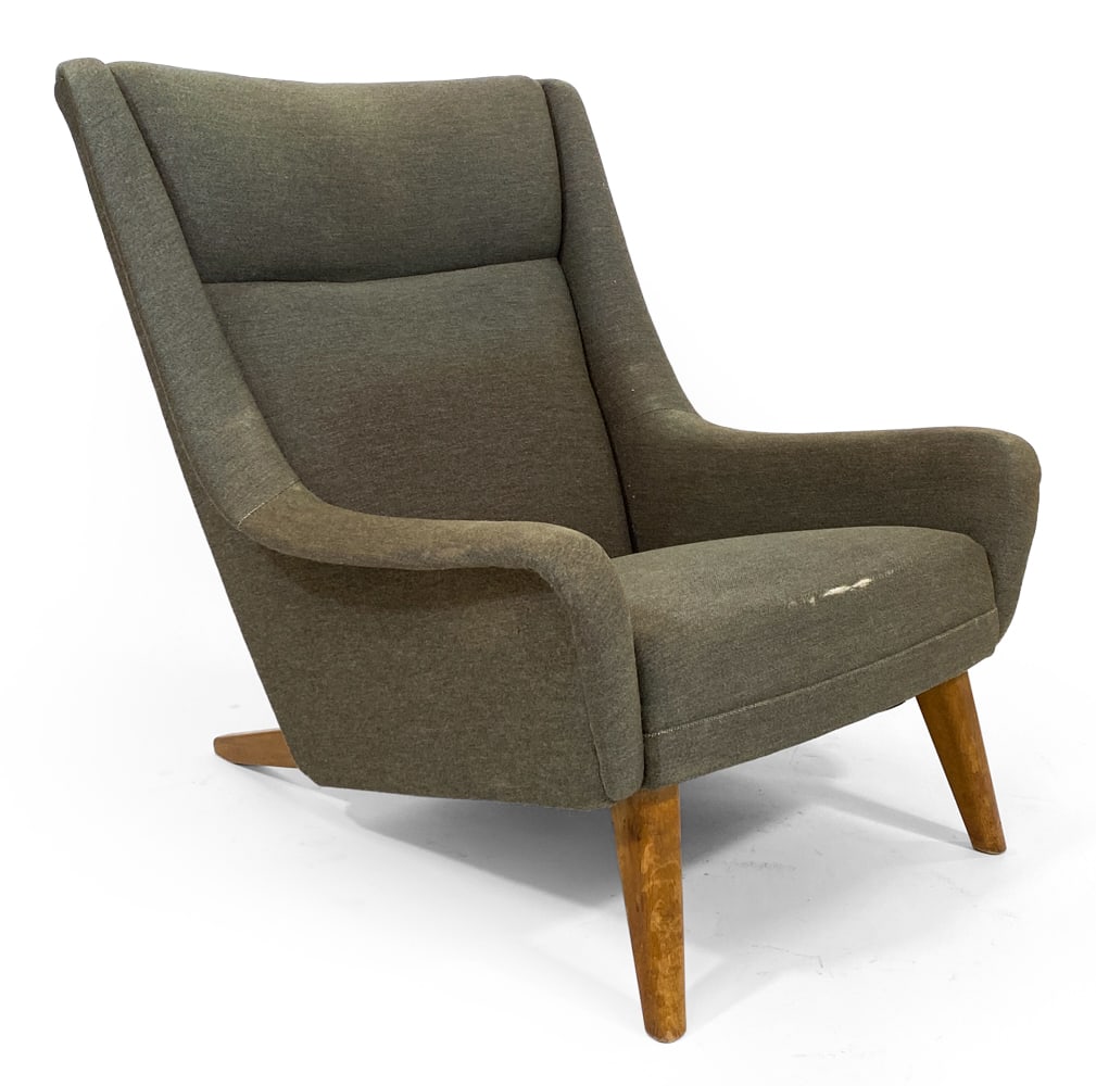 FOLKE OHLSSON STYLE SWEDISH LOUNGE CHAIR 1960S: High-back lounge chair on beech splayed legs with slightly winged wing and armrests in grey upholstery. Sweden, circa 1960s. Dimensions: H 36" x W 31" x D 35" x SH 14.5". Condition: Reupholstery recom