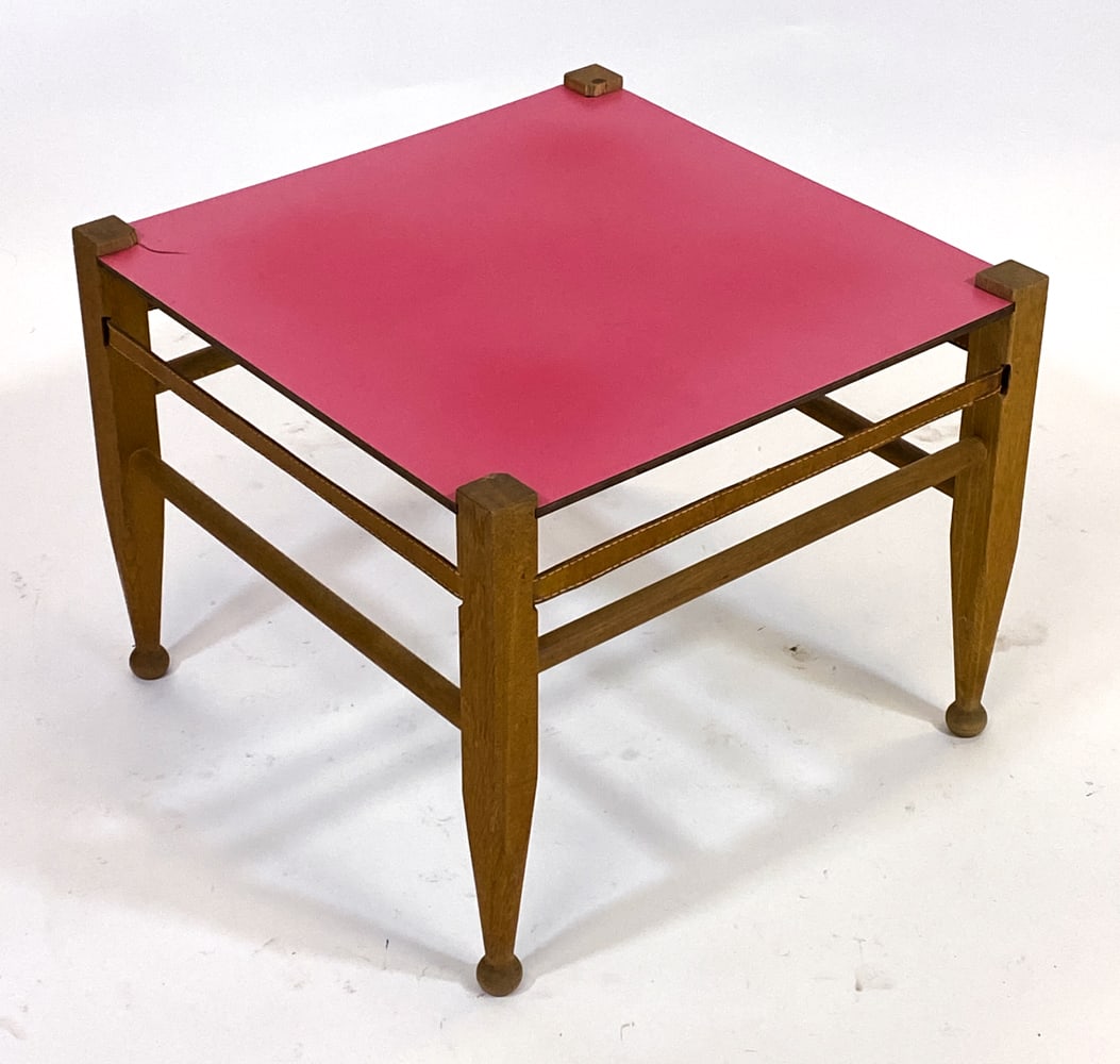 ATTR. KAARE KLINT DANISH OAK SIDE TABLE C. 1960S: Danish safari coffee table or side table in oak frame with laminate top. Leather straps to sides. Denmark, circa 1960s. Dimensions: H 18" x W 22.5" x D 22.5". Condition: Laminate layer underneath top