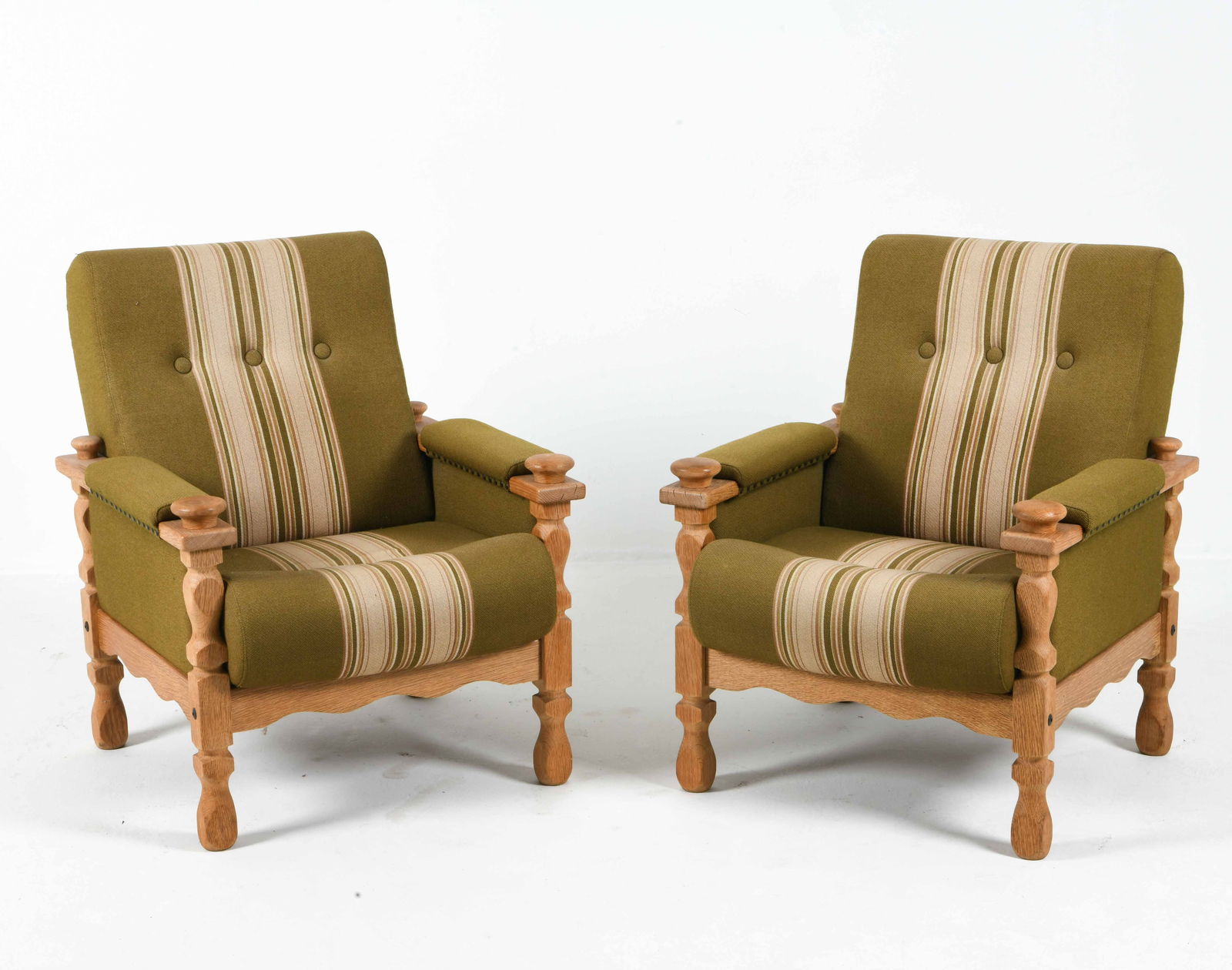 PAIR MANNER OF HENNING KJAERNULF LOUNGE CHAIRS: Oak frames with striped green wool upholstery. Denmark, circa 1970s. Dimensions: H 34.5" x W 25.5" x D 27.25" x S.H. 18". Condition: Wear consistent with age and use, scuffs and scratches.