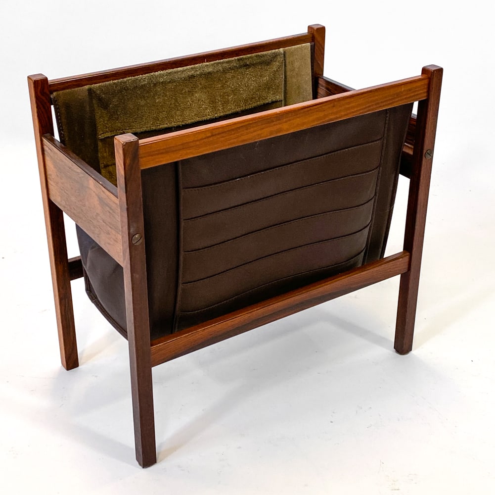 TORBJORN AFDAL ROSEWOOD & LEATHER MAGAZINE RACK: Rosewood frame with leather sling. Apparently unmarked. Denmark, circa 1960s. Dimensions: H 17" x W 18" x D 10.25". Condition: Scuffs to wood, wear consistent with age and use. Soiling and patina to l