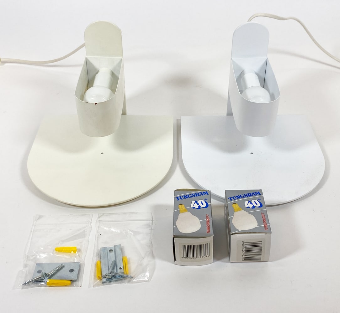 PAIR OF JORGEN KLINKBY LYSKAER 'KASKET' SCONCES: Designed by Jorgen Klinkby for Lyskaer. In original packaging. Steel sconces in white finish. Denmark, circa 1980s. Dimensions: Each H 7" x W 9" x D 9.5". Boxes H 7" x W 9" x D 9.75". Condition: Boxes