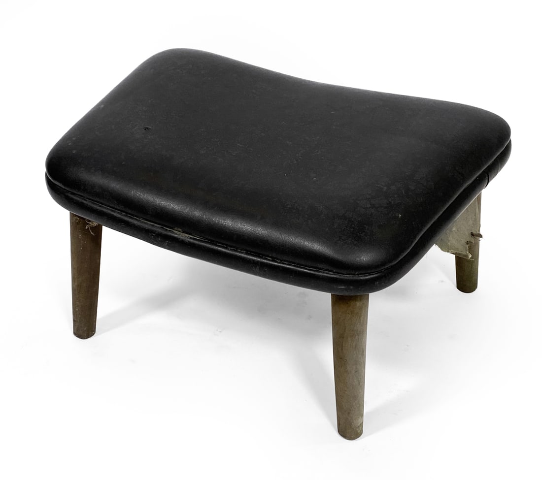 MADSEN & SCHUBELL STYLE DANISH OTTOMAN 1950S: Black leather upholstery with painted beech legs. Denmark, circa 1950s. Dimensions: H 11" x W 20.5" x D 14.75". Condition: Minor scuffs and rubs to leather, minor rubs to legs. Wear consistent with ag