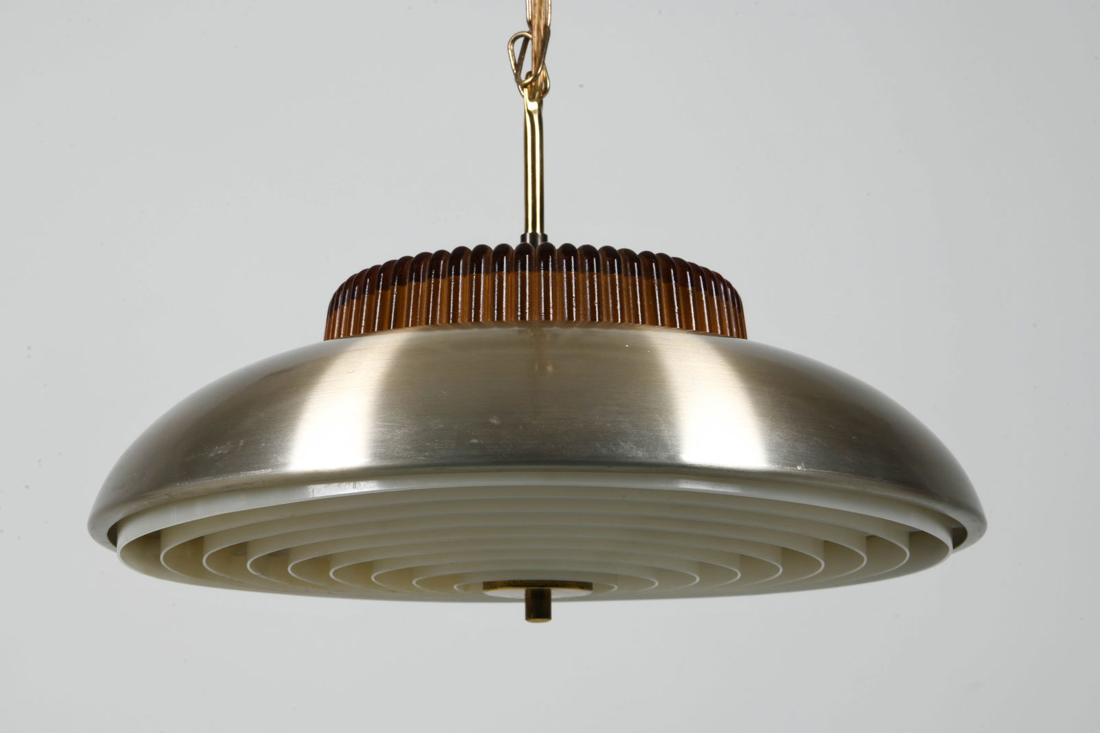 DANISH GLASS SAUCER PENDANT LIGHT C. 1970S: Pendant light with amber glass inner shade. Plastic diffuser underneath. Denmark, circa 1970s. Dimensions: H 10" x Dia. 15.5". Chain L 35". Condition: Wiring untested. Minor scratches. Wear consistent