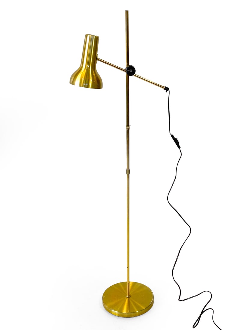 DANISH BRASS FLOOR LAMP C. 1970S: Brass floor lamp with adjustable lamp head on swing arm. Denmark, circa 1970s. Dimensions: H 53" x W 15" x Dia. Base 10". Condition: Wiring untested, European plug. Minor scuffs and scratches. Small o
