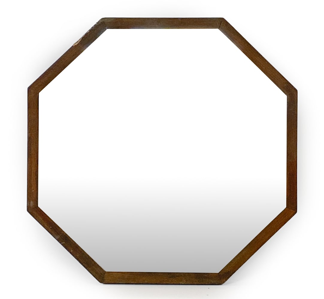 SCANDINAVIAN OCTAGONAL WALL MIRROR C. 1970S: Oak octagonal frame with beveled glass. Scandinavian, circa 1970s. Dimensions: H 23.5" x W 26". Condition: Scuffs and rubs to frame with small dings, few shallow gouges to edges. De-silvering to backi