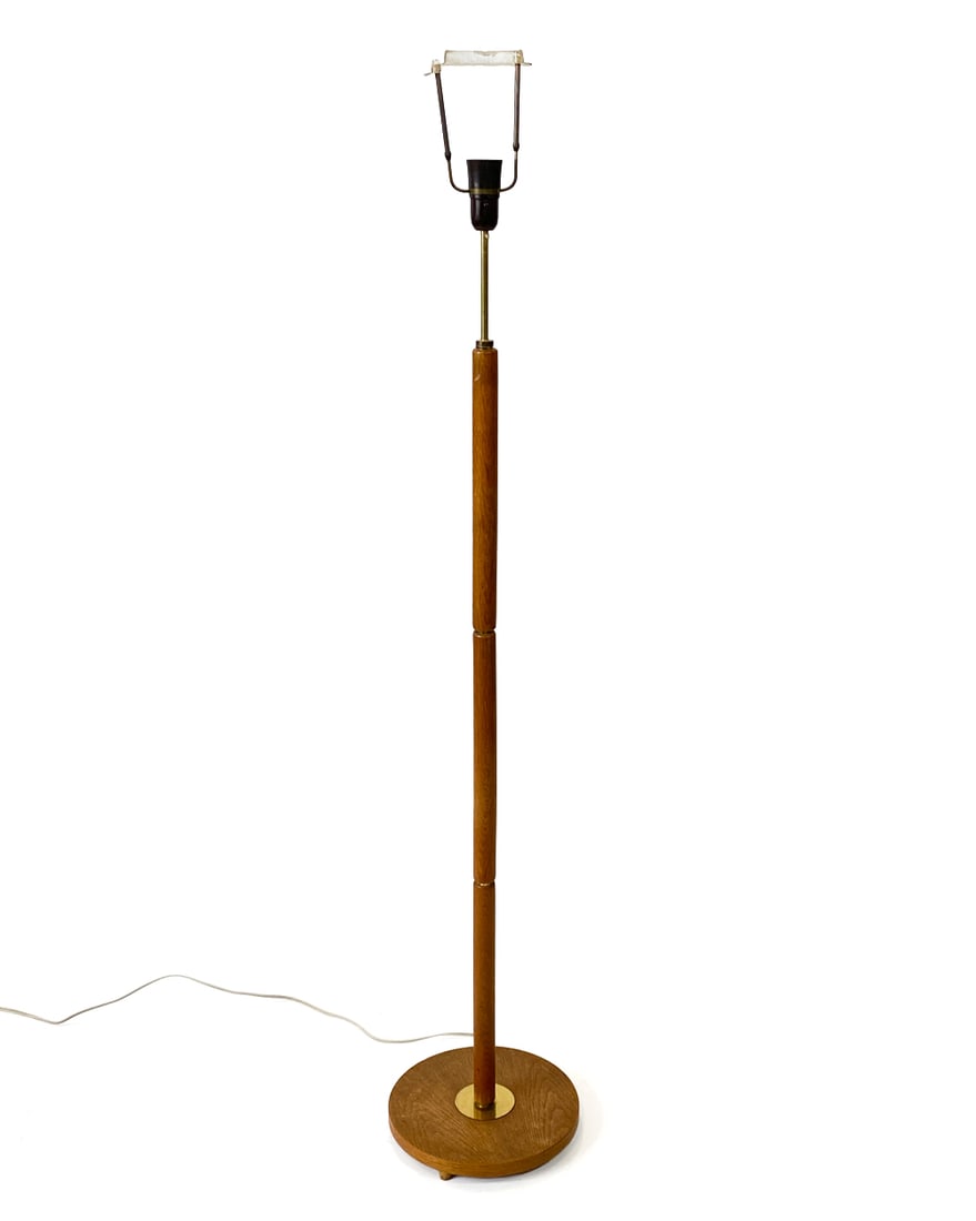 DANISH OAK & BRASS FLOOR LAMP C. 1970S: Oak floor lamp with brass accent to base. Denmark, circa 1970s. Dimensions: H 57" x Dia. 10.75". Condition: Wiring untested, European plug. Minor scuffs and rubs to brass. Wear consistent with age and