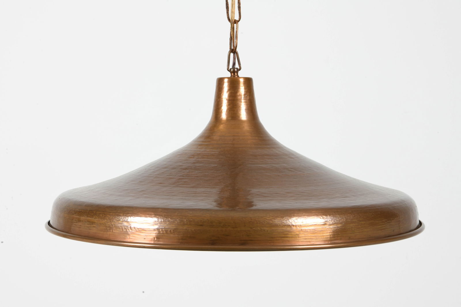 DANISH HAMMERED COPPER PENDANT LIGHT C. 1970S: Hammered copper pendent light in saucer shape. Denmark, circa 1970s. Dimensions: Dia. 20". H 10". Chain Length 42". Condition: Wear consistent with age and use. Wiring untested.
