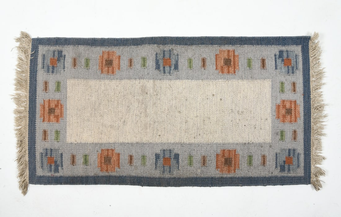 SWEDISH WOOL KILIM RUG C. 1960S: Hand-knotted wool rug in blue, cream, and green geometric patterns. Dimensions: L 51" x H 21". Condition: Minor fading, wear consistent with age and use.