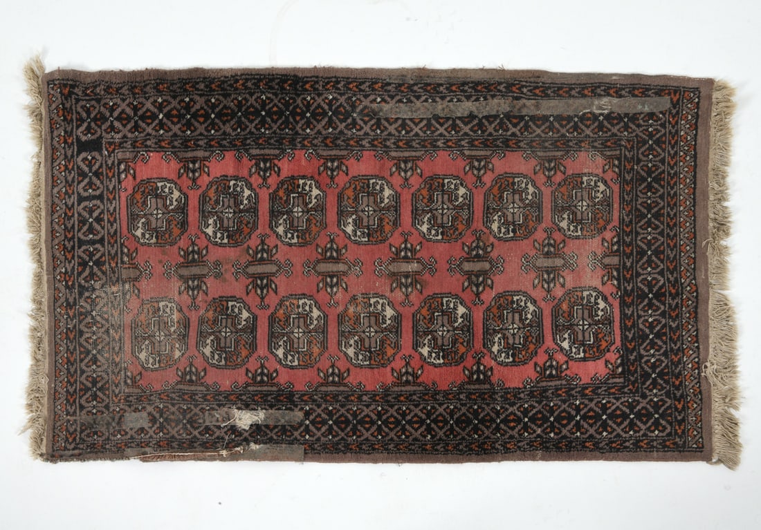 HAND-KNOTTED AFGHAN BOKHARA WOOL RUG: Hand-knotted wool rug with geometric 'gul design. Mid 20th century. Dimensions: L 63.5" x W 36". Condition: Old adhesive remnants. Surface soiling. Wear consistent with age and use.