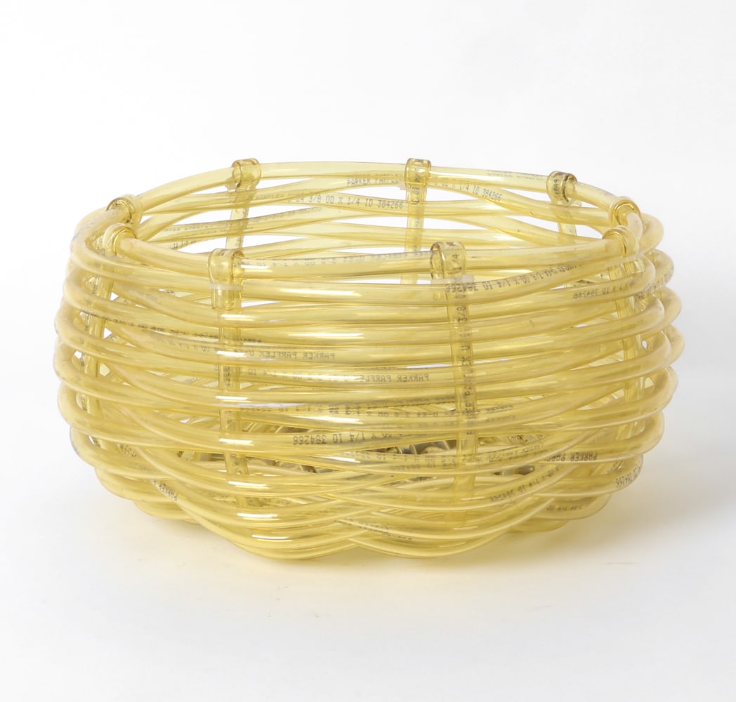 URBAN ARCHAEOLOGY DECORATIVE TUBE BASKET: Decorative woven basket made off vinyl tubing. Dimensions: H 6" x Dia 12" Condition: Wear consistent with age and use. Couple of rubs.