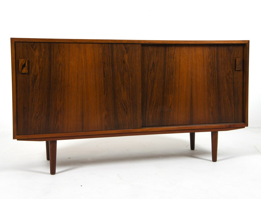 DAMMAND & RASMUSSEN DANISH ROSEWOOD SIDEBOARD: Adjustable shelves and felted drawer. Tagged on back top corner. Denmark, circa 1960s. Dimensions: H 30.5" x W 56.5" x D 17.5". Condition: Showing light signs of wear consistent with age and use. J008