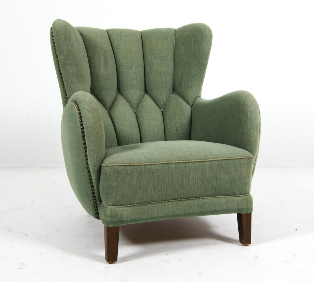 STYLE OF FLEMMING LASSEN DANISH LOUNGE CHAIR 1930S: Lounge chair in green upholstery with channel back. Beech legs. Brass tacks accents. Denmark, circa 1930s. Dimensions: H 38" x W 32" x D 32" x SH 15.5". Condition: Minor scuffs to legs. Wear
